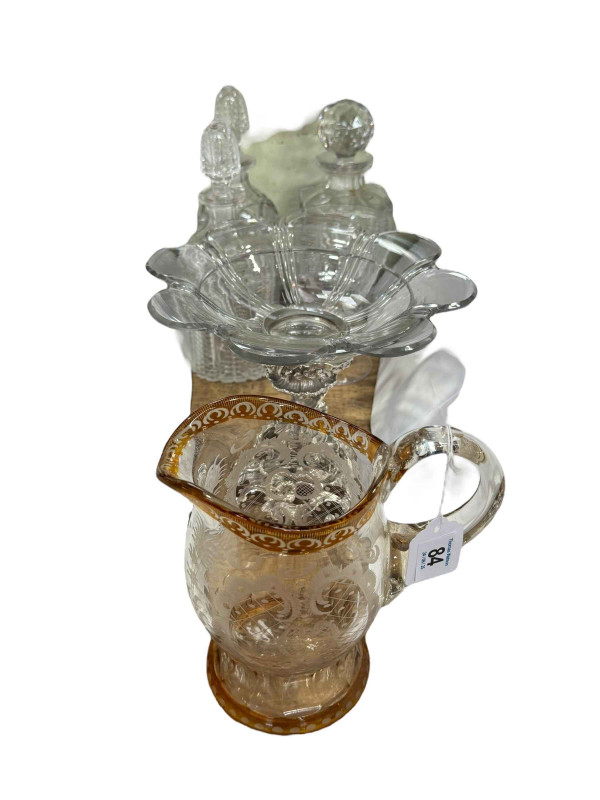 EPNS and glass centre piece, three decanters, engraved jug and large stemmed glass.