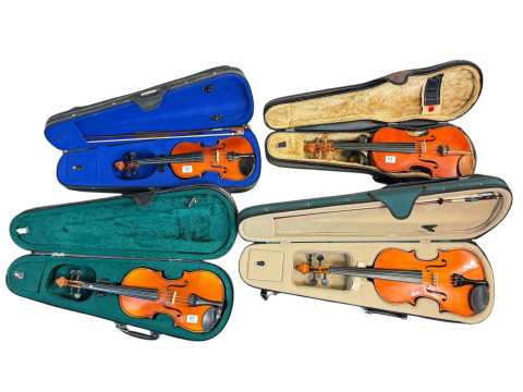 Collection of four cased violins.