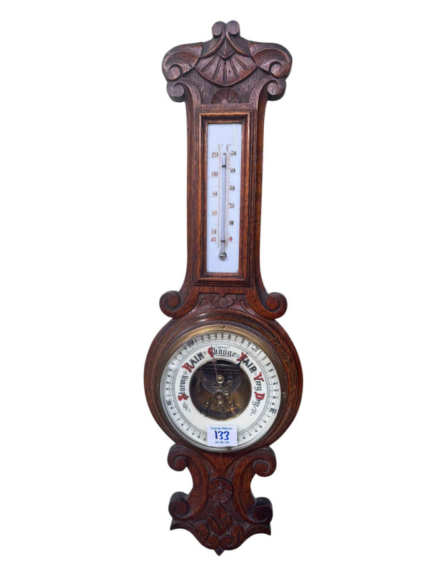 Victorian brass oil lamp with clear glass reservoir and ruby shade, and oak barometer.