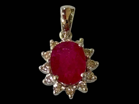 18 carat white gold, ruby and diamond cluster pendant.