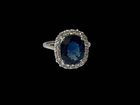 18 carat white gold oval sapphire and diamond cluster ring, size O.