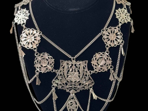 Highly ornate silver necklace.