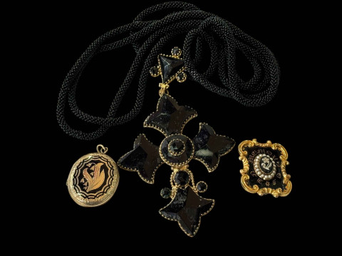 Mourning jewellery comprising locket, brooch and large cross pendant.