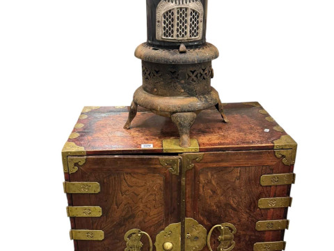 Oriental brass bound cabinet having two doors enclosing eight drawers...