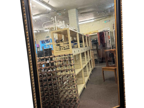 Large black and gilt framed bevelled wall mirror, 203cm by 141cm including...