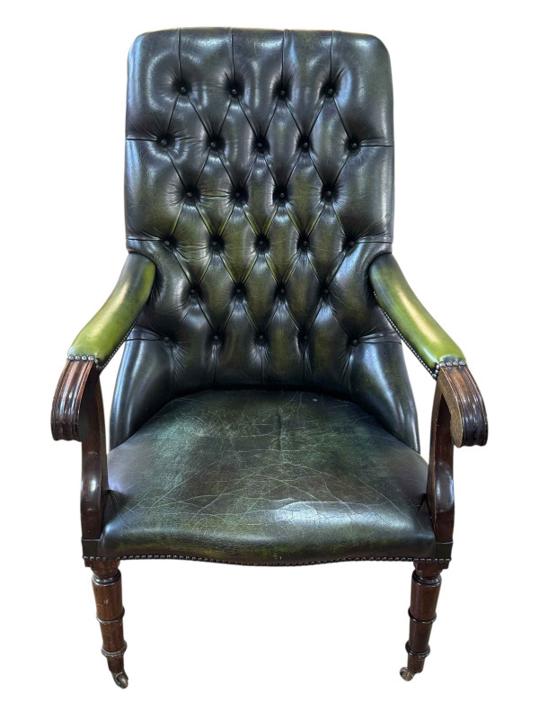 Green buttoned leather and studded turned leg library chair.