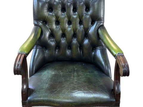 Green buttoned leather and studded turned leg library chair.