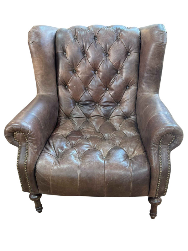 Alexander & James tan buttoned leather and studded wing armchair.