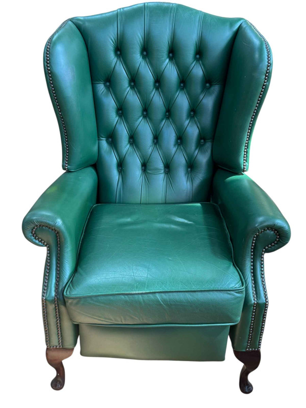 Green buttoned leather and studded wing back reclining armchair.