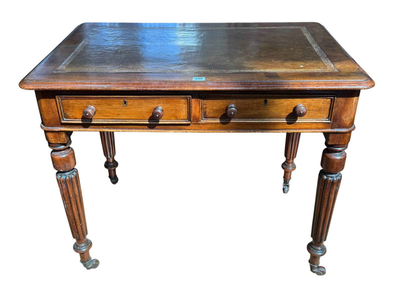 Gillows style mahogany two drawer writing table on turned tapering fluted legs, 74cm by 91cm by 61cm.