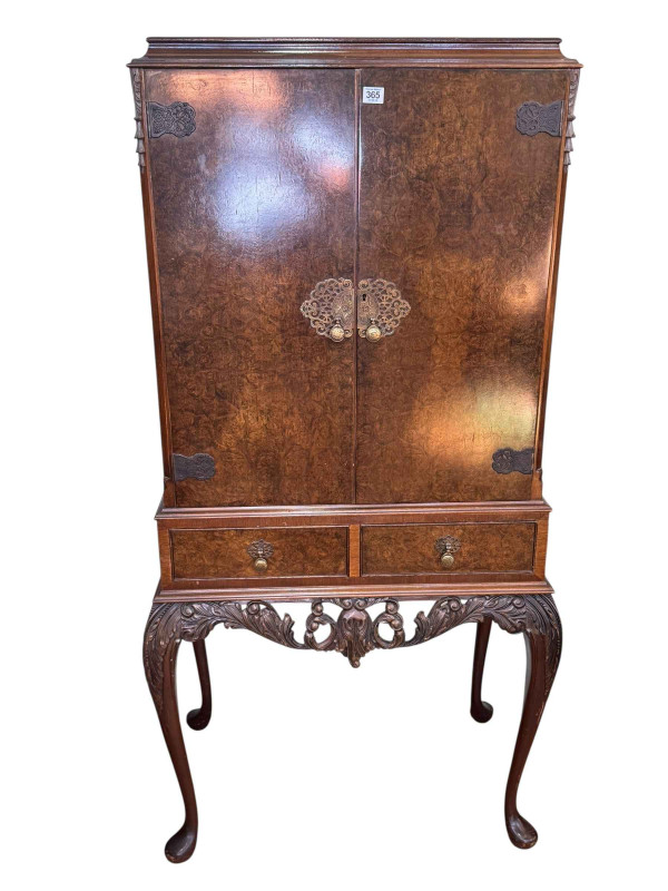 Burr walnut cocktail cabinet having two doors above two drawers on cabriole legs, 152.5cm by 77cm by 49cm.
