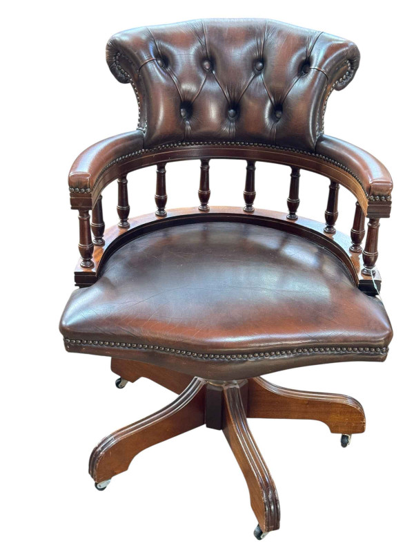 Brown buttoned leather captains style swivel office desk chair.