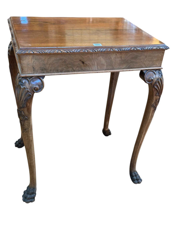 Walnut side table on cabriole legs to paw feet, 78cm by 61cm by 45.5cm.
