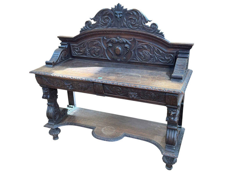 Victorian carved oak buffet having two lion mask carved drawers and shaped undershelf, 120.5cm by 123cm by 46cm.