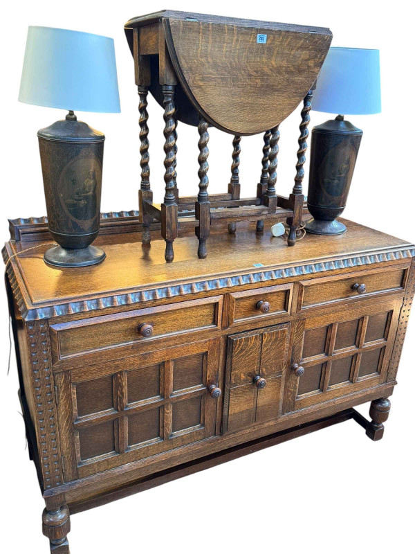 Early 20th Century oak dining furniture comprising two door sideboard with cellarette drawer, barley twist gate leg dining table, smaller barley twist gate leg table, three dining chairs and stool in matching fabric (7).