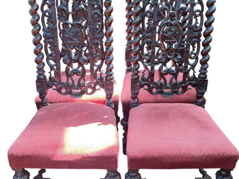Set of four carved oak high back dining chairs with twist supports.