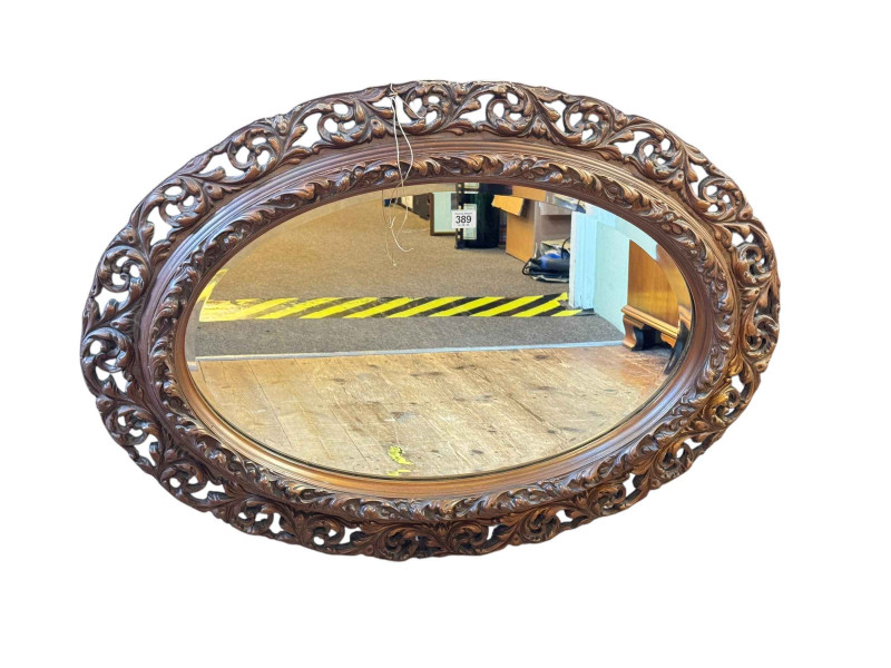 Oval gilt framed bevelled wall mirror, 66cm by 92cm.