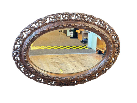 Oval gilt framed bevelled wall mirror, 66cm by 92cm.
