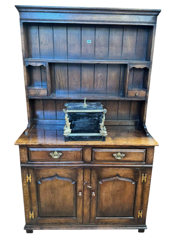 Titchmarsh & Goodwin style oak dresser and rack, the two tier open rack having two small drawers above a base of two drawers and two arched fielded panel doors, 178cm by 106.5cm by 45cm.