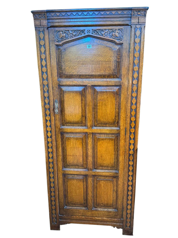 Carved oak hall wardrobe, 181cm by 77cm by 40cm.