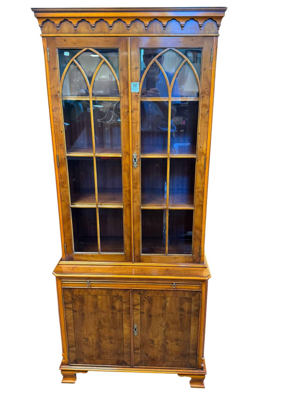 Yew cabinet bookcase having two glazed panel doors above a slide with two cupboard doors below, 176cm by 75cm by 40cm.