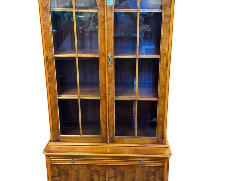 Yew cabinet bookcase having two glazed panel doors above a slide with...
