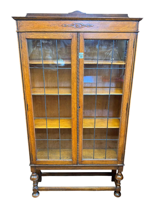 1920's oak leaded two door bookcase, 170cm by 92cm by 26cm.