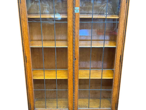 1920's oak leaded two door bookcase, 170cm by 92cm by 26cm.