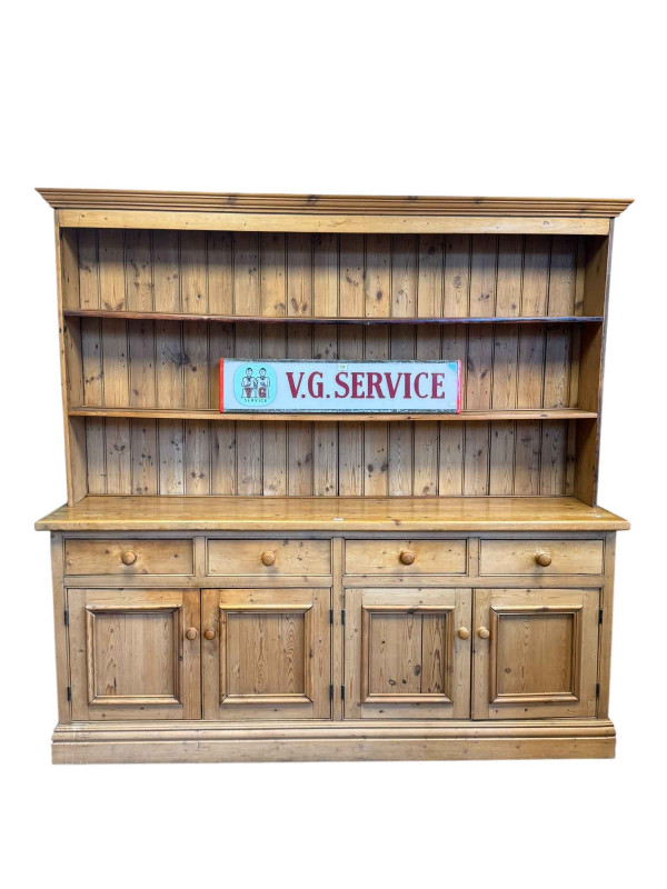 Pine dresser, the two tier shelf back above a base of four drawers and four cupboard doors, 202cm by 208cm by 47cm.