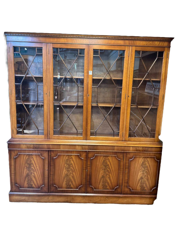 Mahogany cabinet bookcase having four astragal glazed doors enclosing adjustable shelves above four cupboard doors, 191cm by 183cm by 37cm.