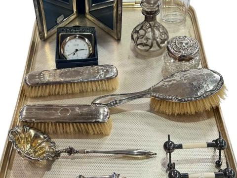 Three silver backed brushes, three silver topped bottles, photo frame,...