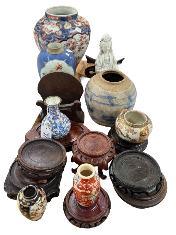 Collection of Oriental wares including jars, vases, wooden stands, etc.
