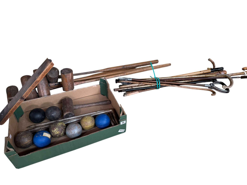Collection of walking sticks, croquet mallets, balls, etc.