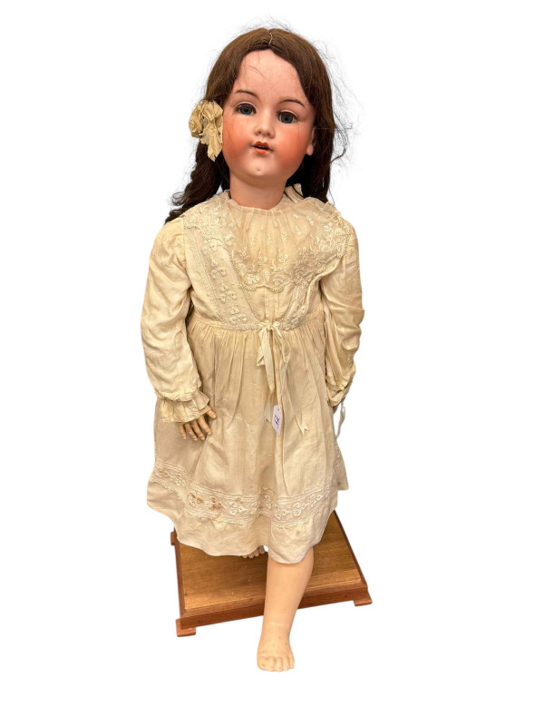 Large Armand Marseille 'Martha' bisque head doll on wood plinth, total height 105cm.