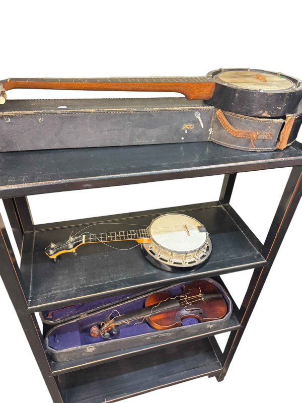 Collection of banjos in cases, violin with bow in case, etc.