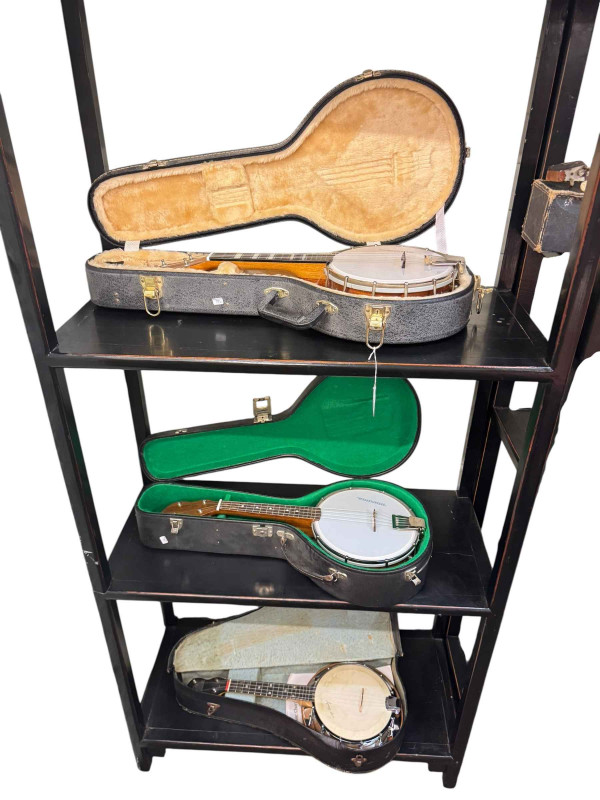 Collection of banjos in cases, violin with bow in case, etc.