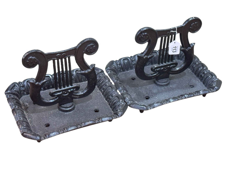 Pair of cast metal harp shaped foot scrapers.