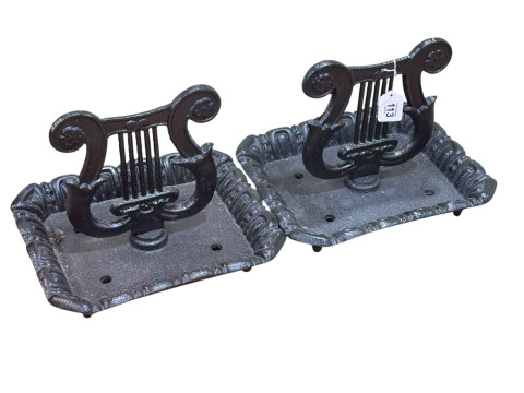Pair of cast metal harp shaped foot scrapers.