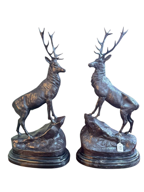 Pair of impressive bronze stags on rocky outcrops raised on marble plinths, 75cm.