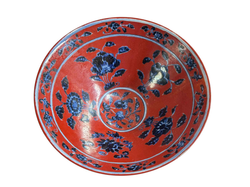 Chinese red ground rice dish with blue floral decoration, six character mark to base, 20cm diameter.