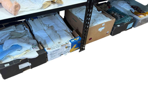 Five boxes of linens, fabrics, etc.