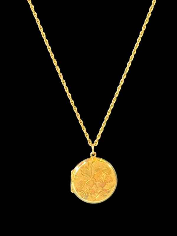 9 carat gold engraved locket and chain.