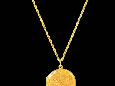 9 carat gold engraved locket and chain.