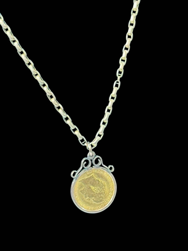 Edward VII gold half sovereign in 9 carat gold pendant mount with chain.