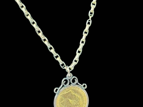 Edward VII gold half sovereign in 9 carat gold pendant mount with chain.