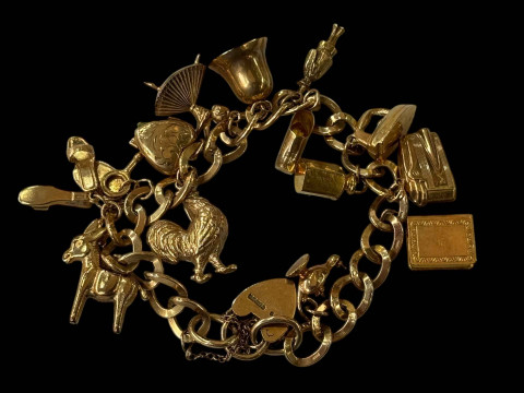 9 carat gold charm bracelet with fourteen gold charms and padlock fastener.