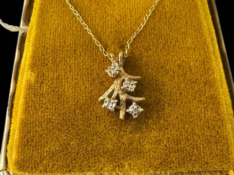 14k gold chain with diamond set branch pendant.