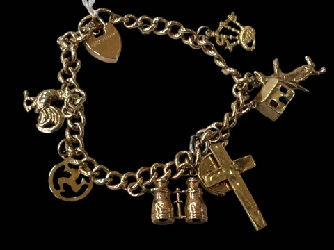 9 carat gold charm bracelet with eight gold charms and padlock fastener.
