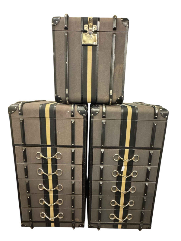 Pair contemporary leather bound lidded five drawer chests, 135cm by 65cm by 58cm, together with a matching trunk, 63cm by 57cm by 57cm (3).