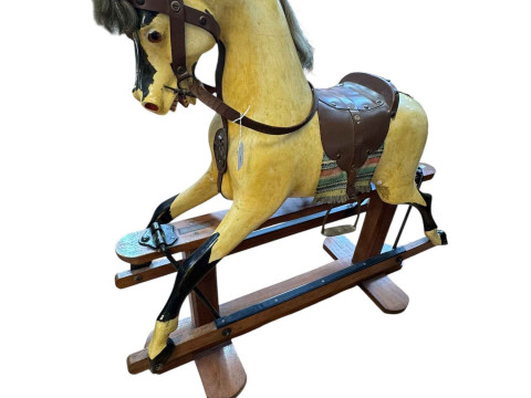 WITHDRAWN   Painted rocking horse with leather saddle on safety stand,...